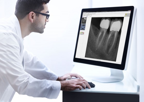 Dentist viewing enhanced digital image onscreen