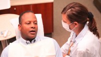 Photo of dental hygienist talking with patient